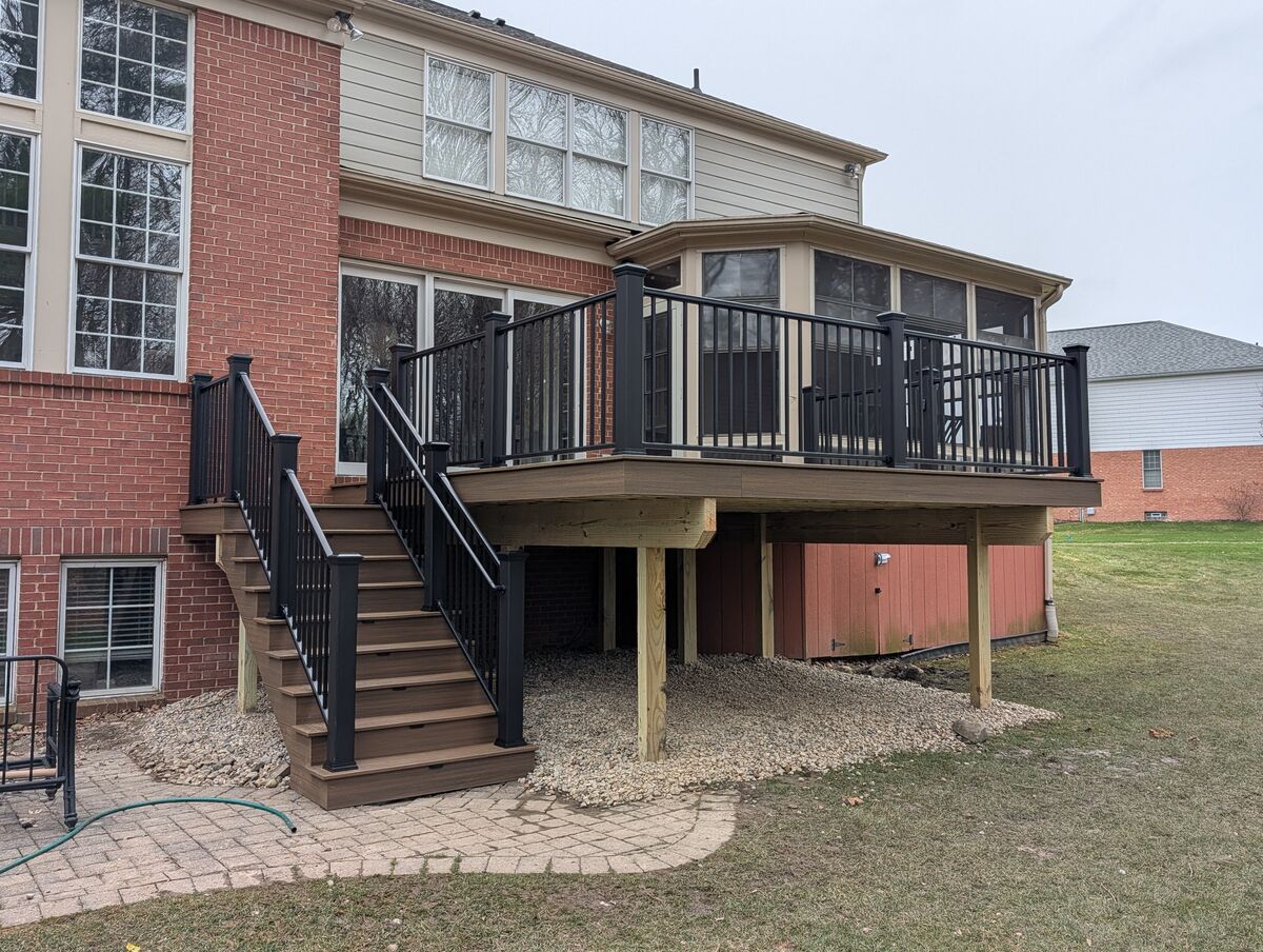 Composite deck with black aluminum railing on a two-story brick home, Canton MI