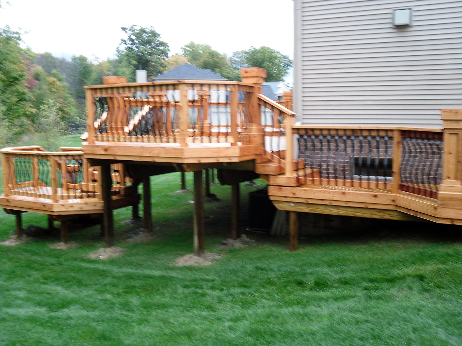 Freshly stained deck with wrought iron rail in Fenton, MI