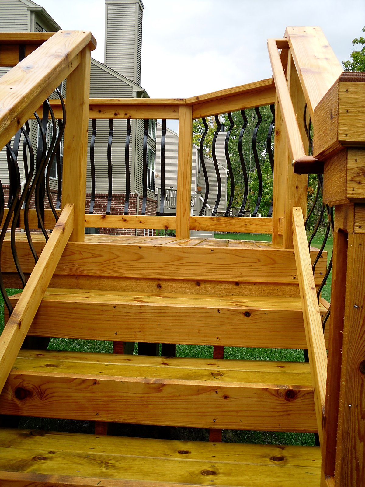 New deck staircase with wrought iron rail in Fenton, MI