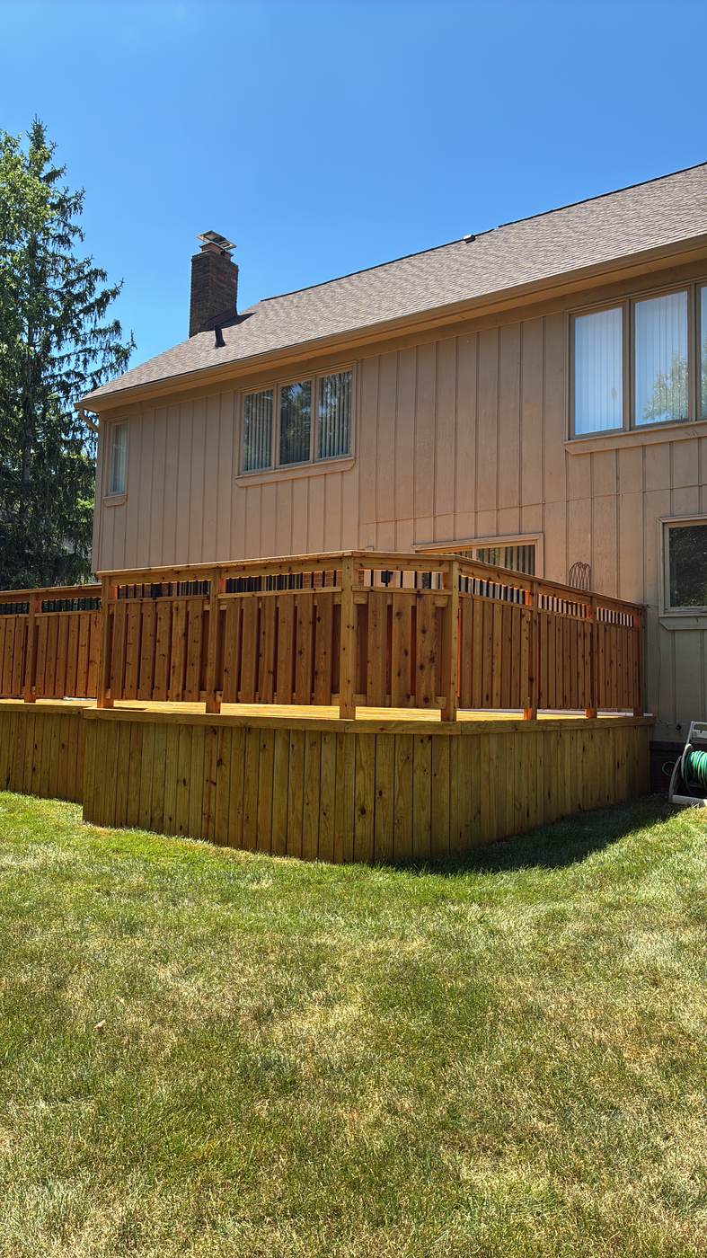 Curved deck staircase on the side of a home in Lake Fenton, MI