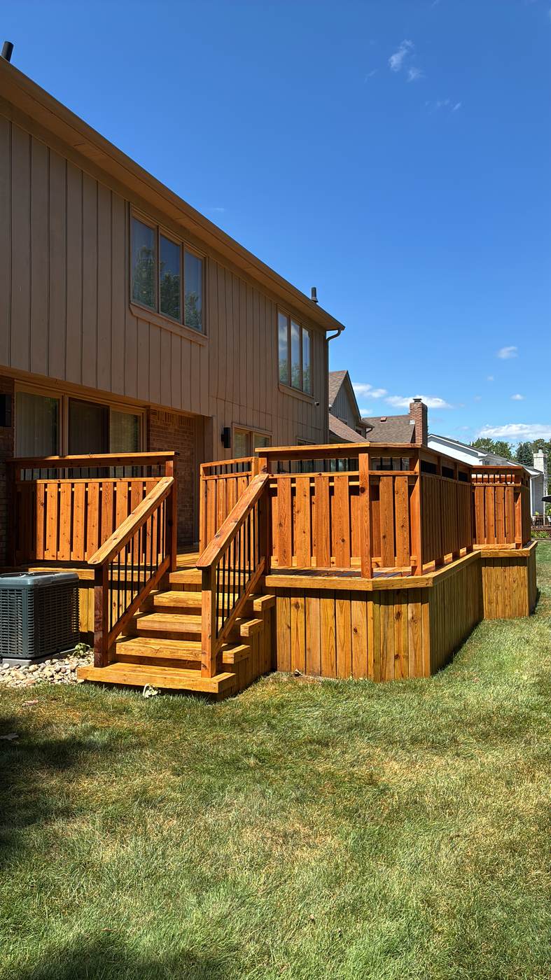 Multi-level deck staircase against a clear blue sky in Trenton, MI