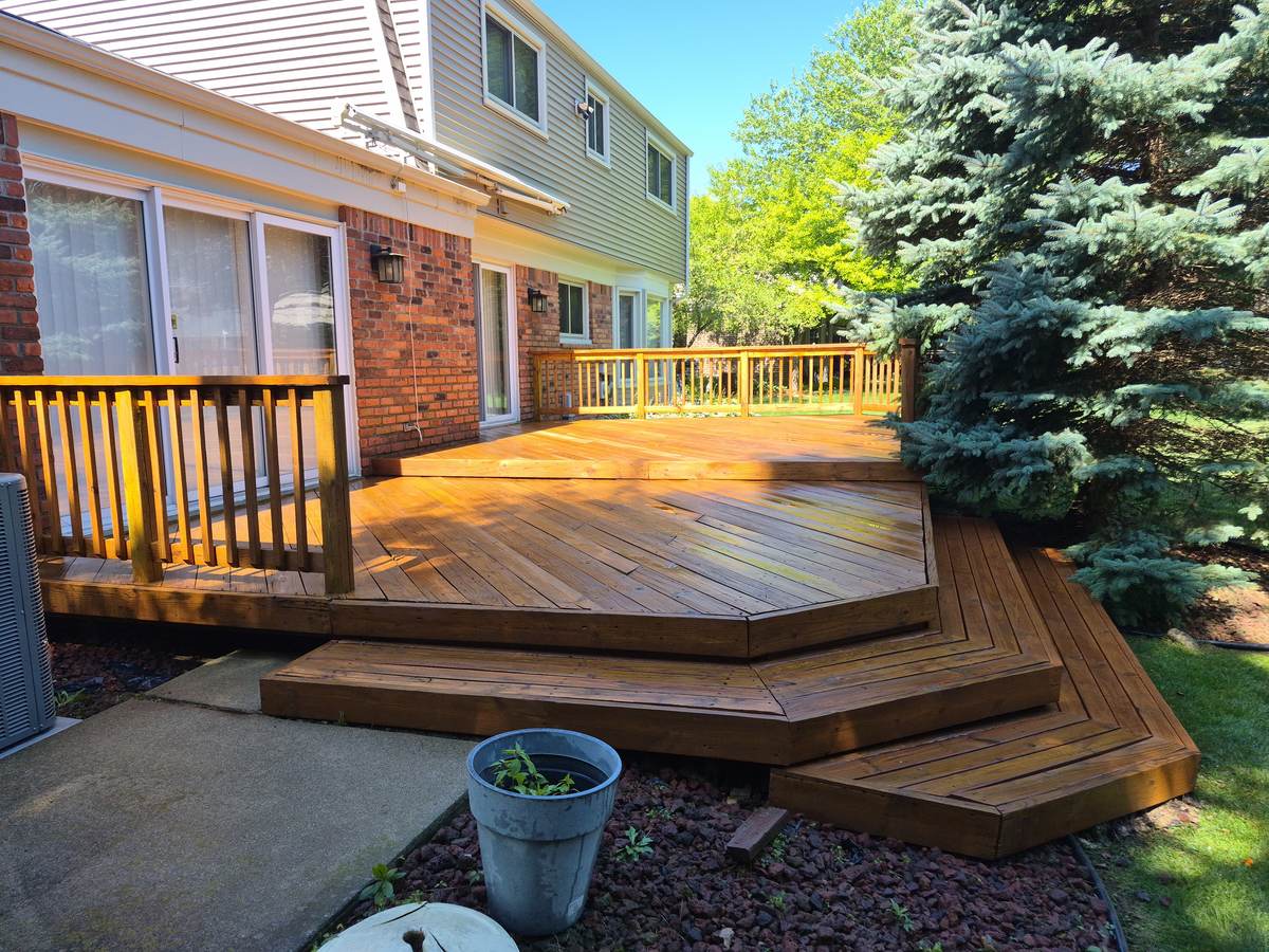 Multi-tier deck surrounded by evergreen trees in Troy, MI