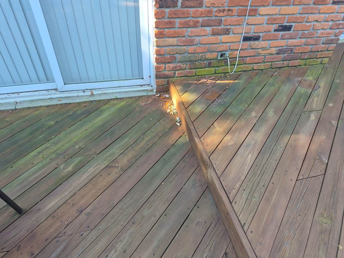 Deck boards being prepped and cleaned before staining, deck restoration in progress in Orion Township, MI