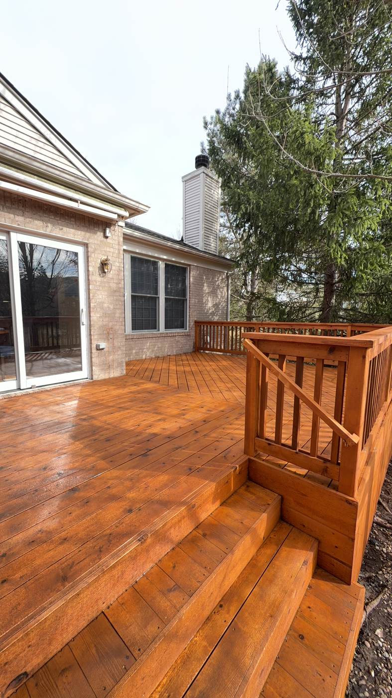Deck staircase under construction against a home's siding in New Boston, MI