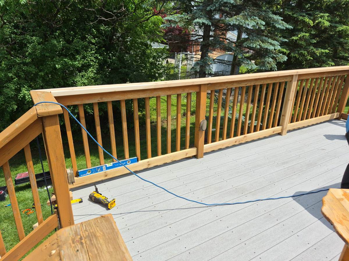 New composite deck under construction with fresh railing installation in Oakland Township, MI