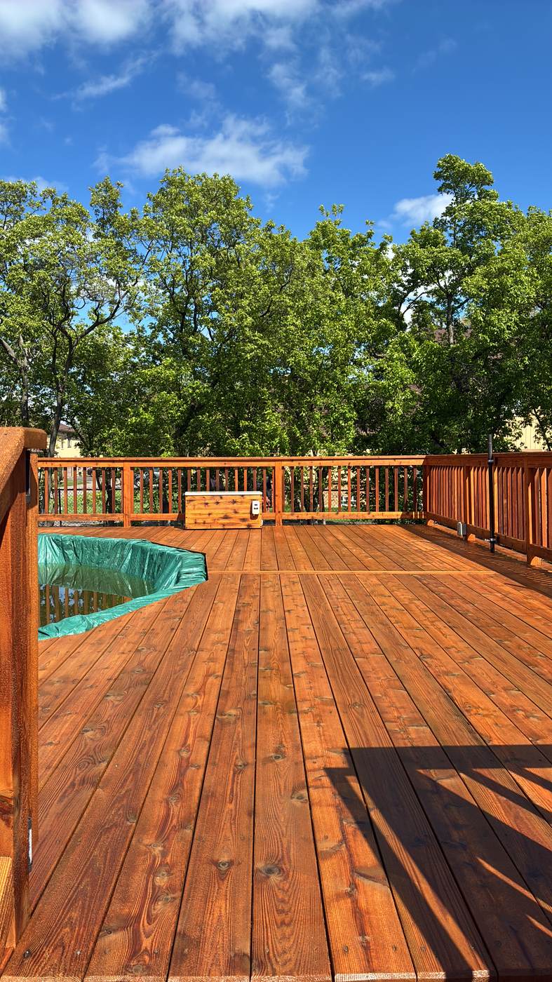 Deck construction in progress against a clear blue sky in Plymouth, MI