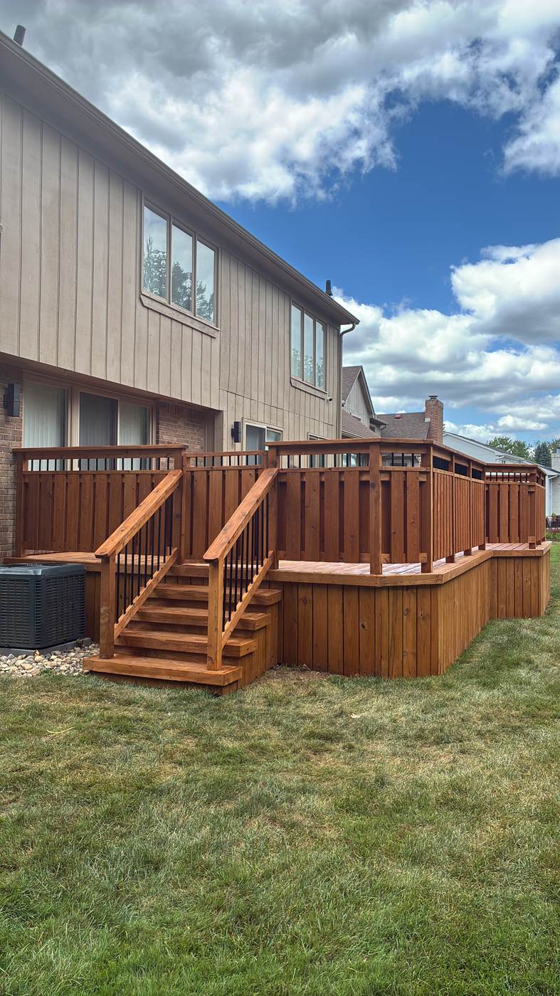 Tall multi-story deck staircase under construction on a two-story home in Wayne, MI