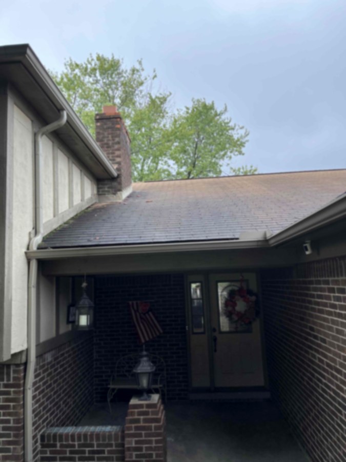 Roof before soft washing, streaked with algae in Southeast Michigan