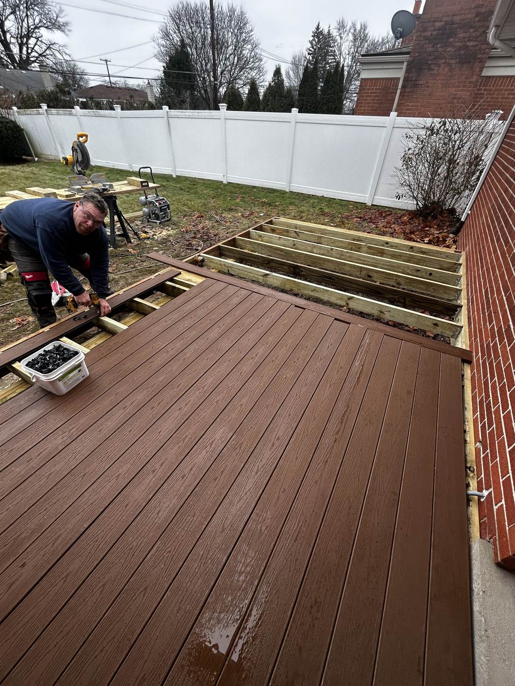 Pressure washing a wood deck during a deck cleaning service in Swartz Creek, MI